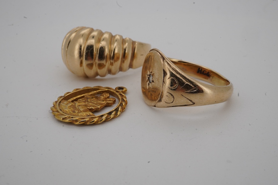 A 9ct gold and diamond set signet ring, size M/N, a fluted 9ct gold ring and a 9ct gold St. Christopher's charm, gross weight 13.2 grams.